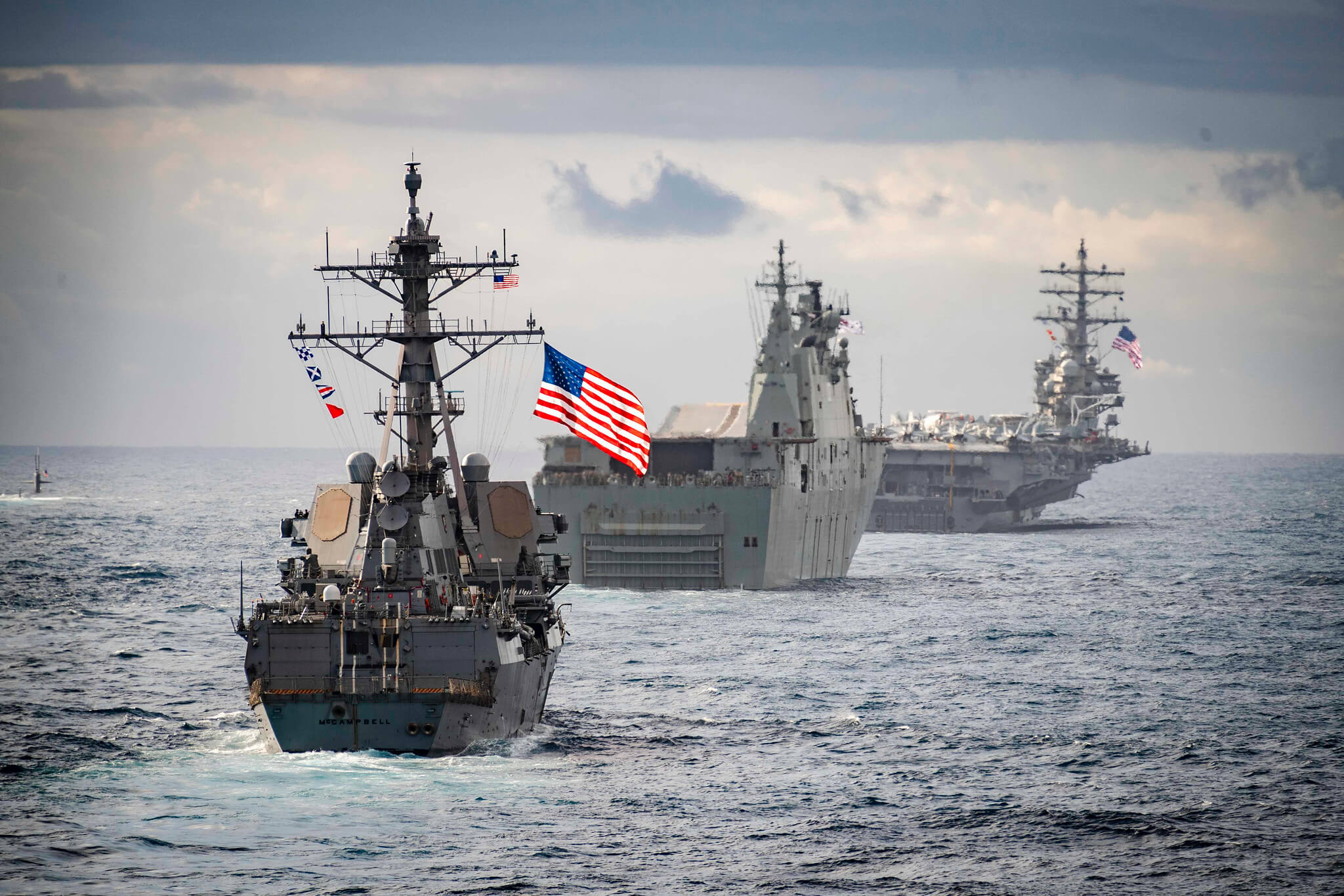 Lindley-French-The guided-missile destroyer USS McCampbell sails behind the Royal Australian Navy amphibious assault ship HMAS Canberra and the aircraft carrier USS Ronald Reagan at the Coral Sea in 2019.